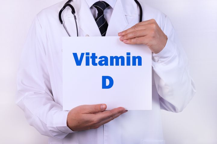 Doctor holds a sign of Vitamin D, medical concept.