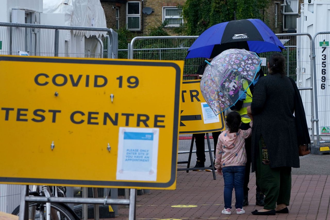 People queue outside a Covid-19 testing centre in Walthamstow.