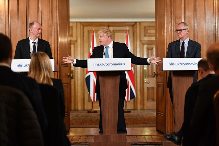 Prime minister Boris Johnson, centre, gestures to chief medical officer Chris Whitty, left and chief scientific adviser Sir Patrick Vallance, during a coronavirus news conference at 10 Downing Street, in London in March