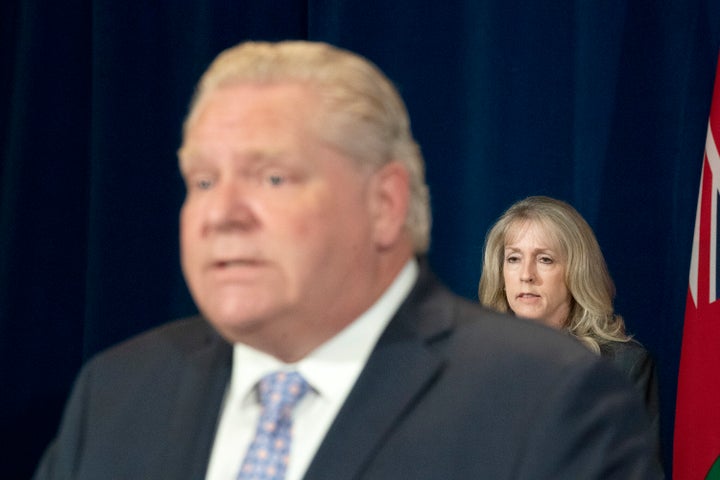 Ontario Minister of Long Term Care Merrilee Fullerton listens as Premier Doug Ford speaks in Toronto on May 28, 2020.