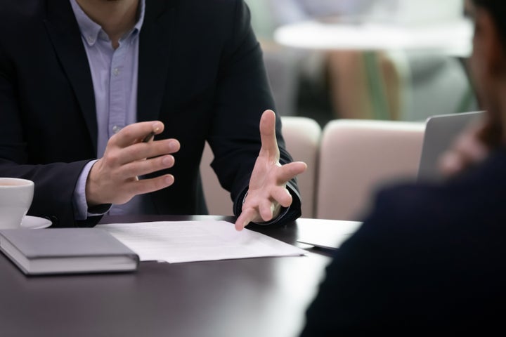 Close up businessman negotiating explaining agreement details to partner. Professional lawyer banker salesman real estate agent talking to client, discussing contract conditions, making offer propose.