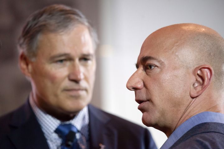 Washington Gov. Jay Inslee (D), left, joins Amazon CEO Jeff Bezos at an event in Seattle in 2013. It is unclear how much resentment of Bezos' power resonates outside of Seattle.