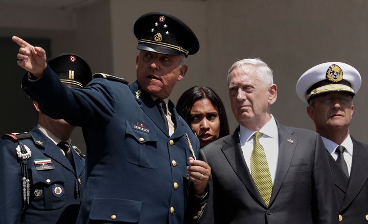 Former Mexican Defense Secretary Gen. Salvador Cienfuegos, left, participates in a ceremony with former U.S. Defense Secretary Jim Mattis in Mexico City on Sept. 15, 2017. Mexico's top diplomat said late Thursday that Cienfuegos has been arrested.