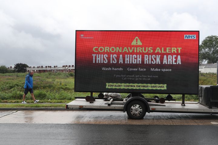 A mobile advertising vehicle displaying a coronavirus high risk area near Greater Manchester, 
