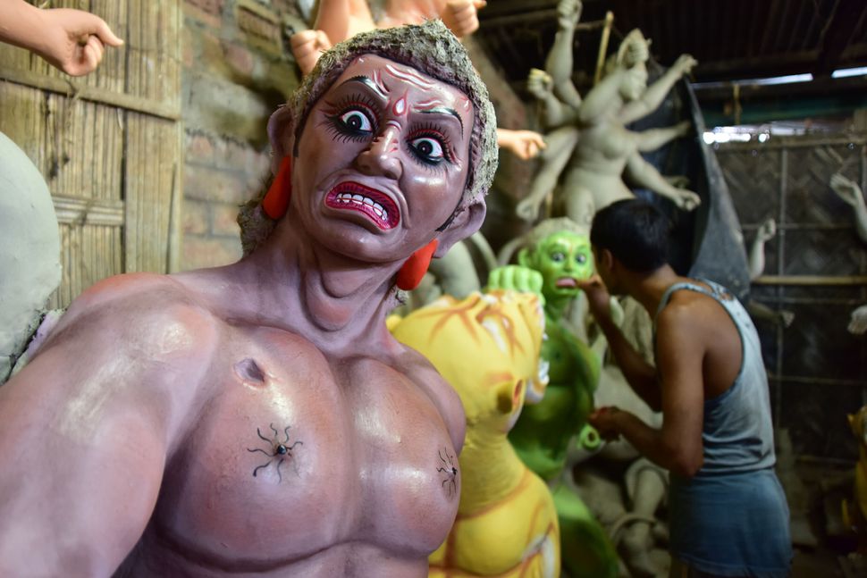 An artist finishing Asura where Durga idols are being prepared ahead of Durga puja in Nagaon District of Assam, October 9, 2020.