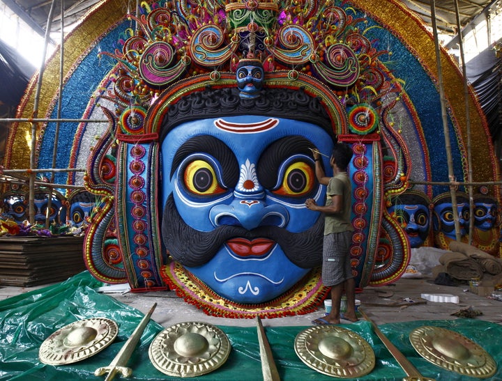 An artist applies finishing touches to a face of demon king Ravana in preparations for the upcoming Durga Puja festival at a pandal, a temporary platform, in Kolkata, India, October 6, 2015. The Durga Puja festival will be celebrated from October 19 to 22, which is the biggest religious event for Bengali Hindus. Hindus believe that the goddess Durga symbolises power and the triumph of good over evil. REUTERS/Rupak De Chowdhuri TPX IMAGES OF THE DAY