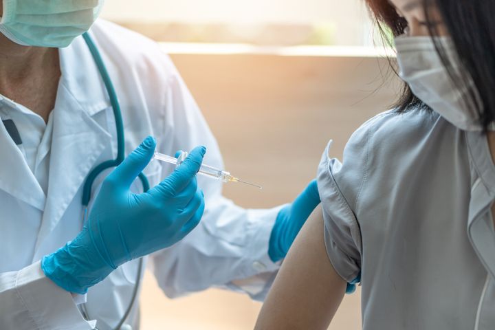 A doctor administers the influenza vaccine. 