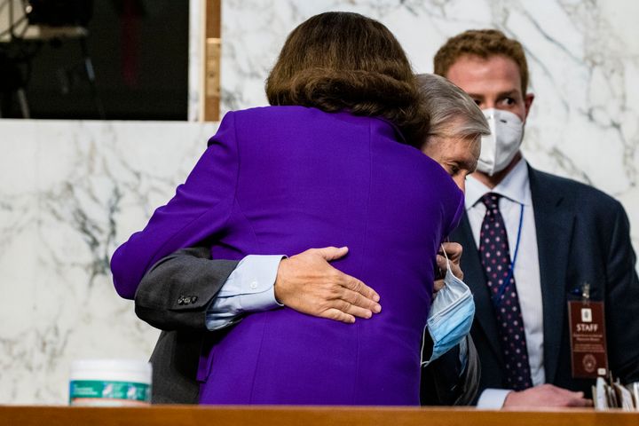 Sen. Dianne Feinstein (D-Calif.) hugs Sen. Lindsey Graham (R-S.C.) as the confirmation hearings for Supreme Court nominee Judge Amy Coney Barrett come to a close on Thursday. Neither senator wore a mask.