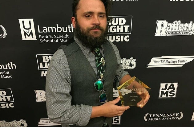 Justin Coffman with his award as bassist of the year in