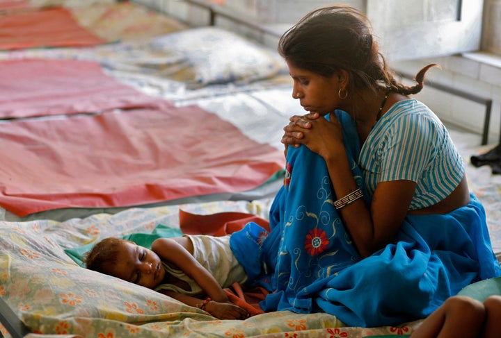 A mother looks at her malnourished child in the Nutritional Rehabilitation Centre of Sheopur district in the central Indian state of Madhya Pradesh April 6, 2010. India ranked 65th out of 84 countries in the Global Hunger Index of 2009, below countries including North Korea and Zimbabwe -- hindering India's ambitions to channel its demographic dividend to fuel its global economic ambitions. Picture taken April 6, 2010. To match feature INDIA-WELFARE/ REUTERS/Reinhard Krause (INDIA - Tags: BUSINESS FOOD HEALTH SOCIETY)