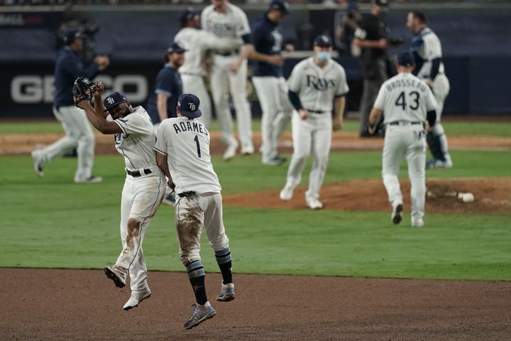 Tampa Bay Rays' Manuel Margot and Willy Adames celebrate their victory in Game 7 of a baseball American League Championship Series, Saturday, Oct. 17, 2020, in San Diego. The Rays defeated the Astros 4-2 to win the series 4-3 games. (AP Photo/Jae C. Hong)