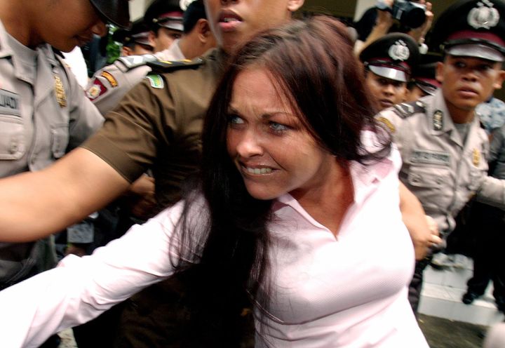 Australian Schapelle Corby, then 27, being escorted by Indonesian police from a court in Denpasar on the Indonesia's resort island of Bali April 7, 2005. 