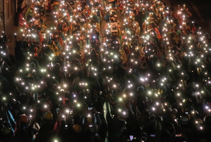 Pro-democracy protesters shine their mobile phone lights during an anti-government protest at Victory Monument during a protest in Bangkok, Thailand, on Oct. 18, 2020. 