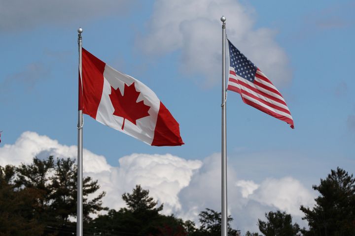 A Canadian and U.S. flag fly at a border crossing in Lansdowne, Ont., on Sept. 28. The border has been closed to control the spread of the novel coronavirus.