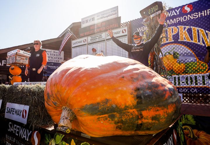 Travis Gienger, a farmer from Anoka, Minnesota, strikes a triumphant pose after winning the Safeway World Championship Pumpkin Weigh-Off in Half Moon Bay, California.