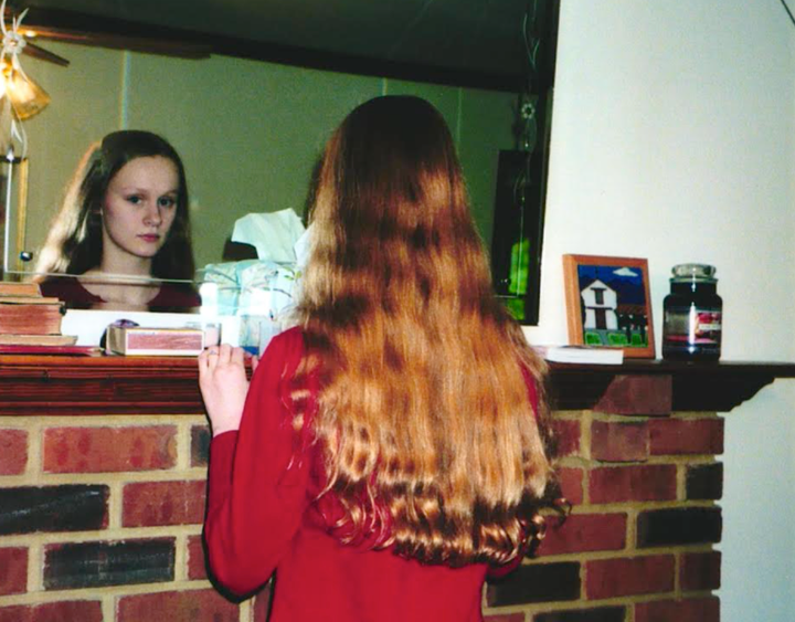 The author documenting hair as her "glory" before a haircut in 2004.