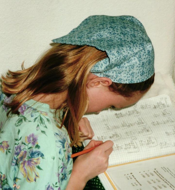 The author doing Rod & Staff homeschool math homework in 2000.