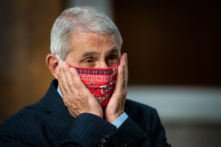 Dr. Anthony Fauci, director of the National Institute of Allergy and Infectious Diseases, adjusts his face mask as he ar