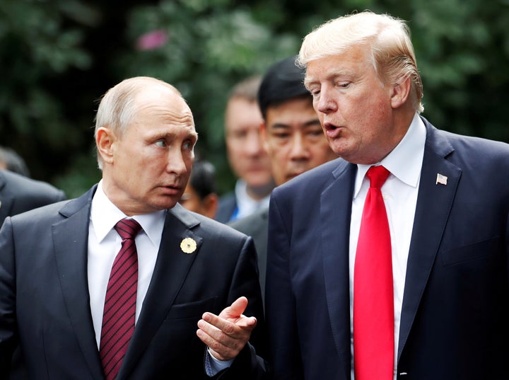 U.S. President Donald Trump and Russian President Vladimir Putin talk during the APEC Summit in Danang, Vietnam, Nov. 11, 2017.