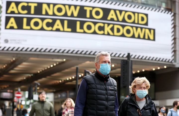 People wearing face masks on Market Street in Manchester.