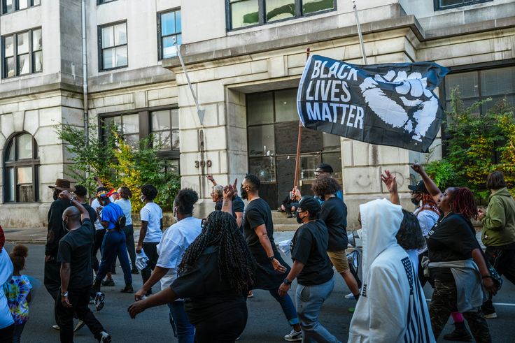 Black Lives Matter protesters march in the street before participating in early voting on October 13 in Louisville, Kentucky. A poll worker in Memphis, Tennessee, was fired Friday after turning away early voters who were wearing “Black Lives Matter” and “I Can’t Breathe” shirts.
