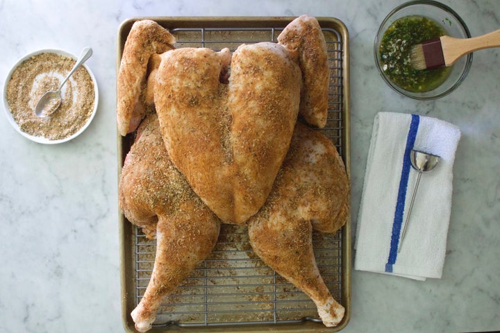 A spatchcocked turkey is covered in a dry brine.