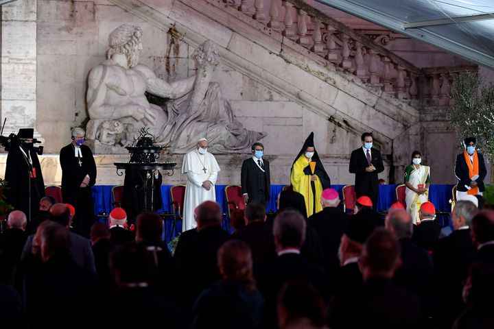 Pope Francis stands with representatives from various religions during an interfaith ceremony for peace in Rome on October 20, 2020. 