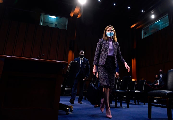 Supreme Court nominee Judge Amy Coney Barrett leaves after testifying on the third day of her confirmation hearing before the Senate Judiciary Committee.