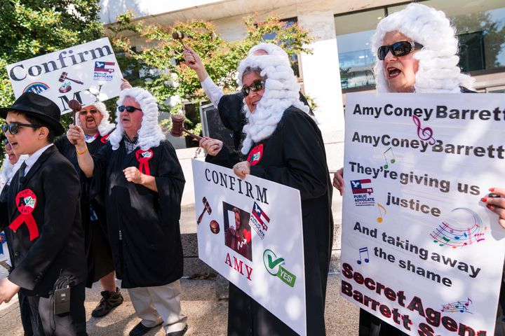 Conservative supporters of Supreme Court nominee Amy Coney Barrett sing a song about their joy at her nomination, outside the confirmation hearing being done by the Senate Judiciary Committee, on Oct. 15, 2020, on Capitol Hill in Washington. 