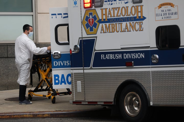 Medical workers walk outside of Maimonides Medical Center in Borough Park, New York City, where three members of the city’s Orthodox Jewish communities died from the coronavirus over the last four days.