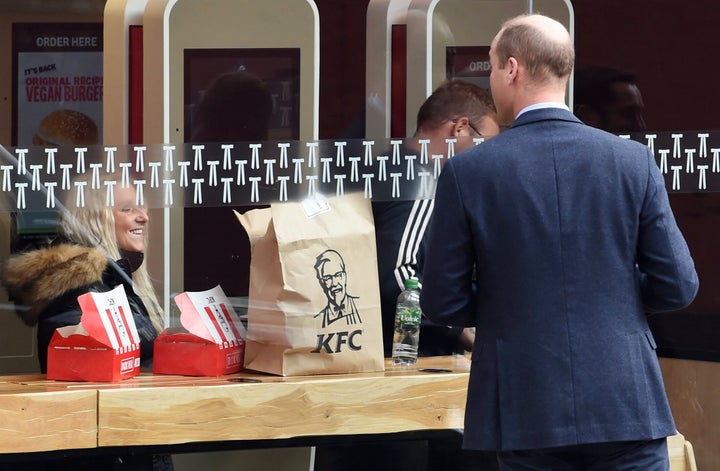 Wiliam speaks to a member of the public through the window of a KFC restaurant at Waterloo Station on Oct. 20 in London. 