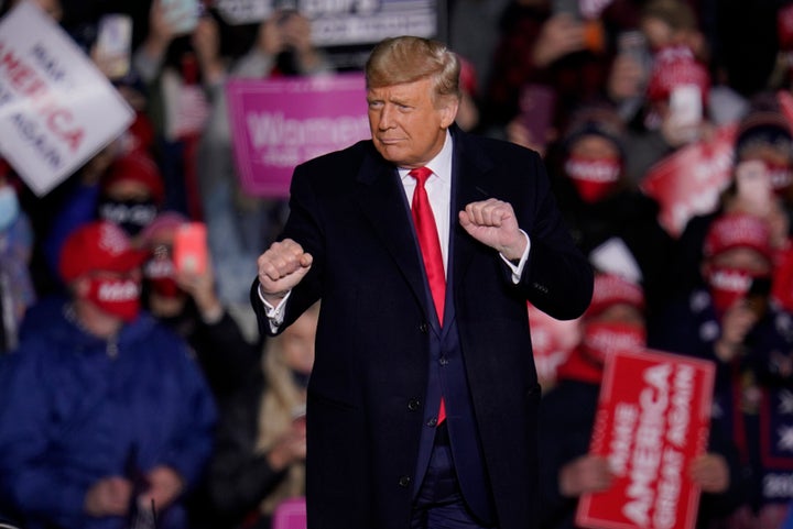 Supporters cheer as President Donald Trump moves to the song "YMCA" at the end of a campaign rally in Erie, Pennsylvania, on Oct. 20.