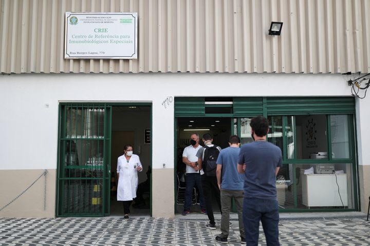 People stand in front of the Reference Center for Special Immunobiologicals (CRIE) of the Federal University of Sao Paulo (Unifesp) where the trials of the Oxford/AstraZeneca coronavirus vaccine are conducted, in Sao Paulo, Brazil, June 24, 2020. 