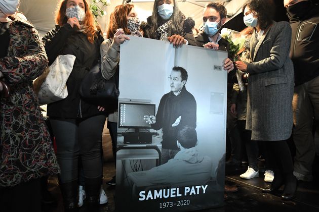 Συγγενείς και φίλοι κρατούν τη φωτογραφία του Σαμιέλ Πατί, του καθηγητή ο οποίος αποκεφαλίστηκε από έναν φανατικό μουσουλμάνο επειδή είχε δείξει στους μαθητές του σκίτσο του Μωάμεθ.
