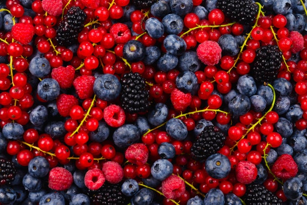 Blackberry, raspberry, blueberry,  red currant and mint background.