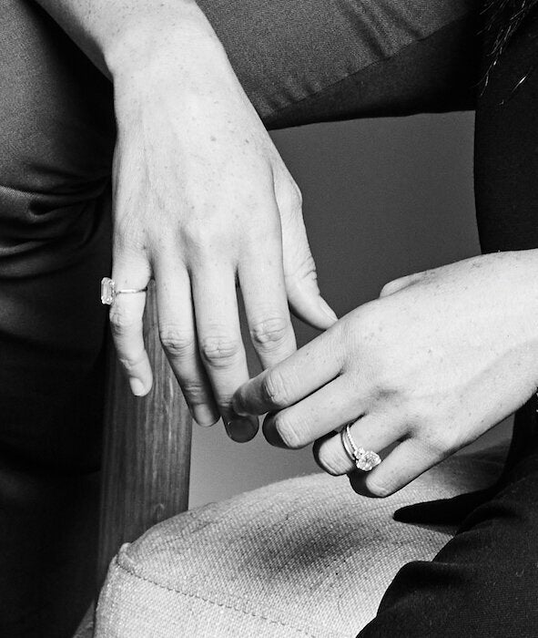 A close-up of Meghan Markle's hands, showing her pinky ring and her engagement ring.