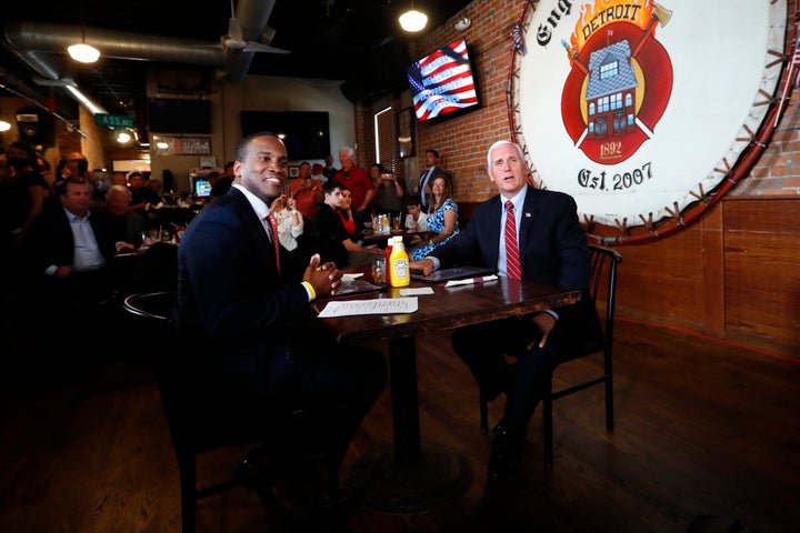 Vice President Mike Pence and Republican U.S. Senate candidate John James sit for lunch at The Engine House in Mount Clemens, Michigan, in June.