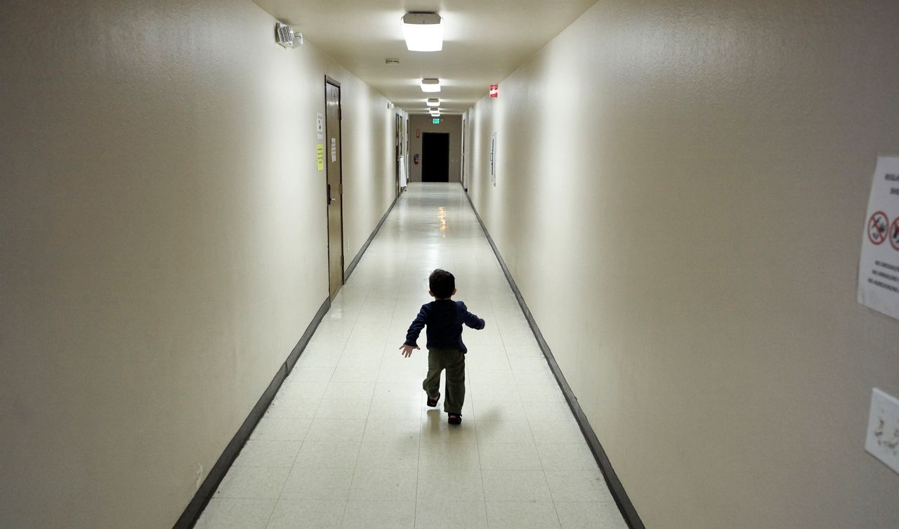 In this 2018 photo, an asylum-seeking boy from Central America runs down a hallway after arriving from an immigration detention center to a shelter in San Diego. The Trump administration separated thousands of migrant children from their families.
