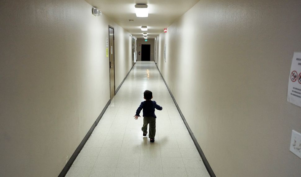 In this 2018 photo, an asylum-seeking boy from Central America runs down a hallway after arriving from an immigration detenti