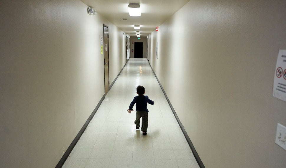 In this 2018 photo, an asylum-seeking boy from Central America runs down a hallway after arriving from an immigration detenti