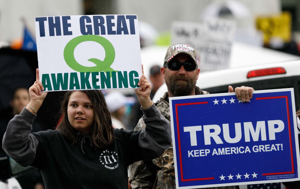 QAnon conspiracy theorists hold signs during a protest at the state Capitol in Salem, Oregon, May 2, 2020.
