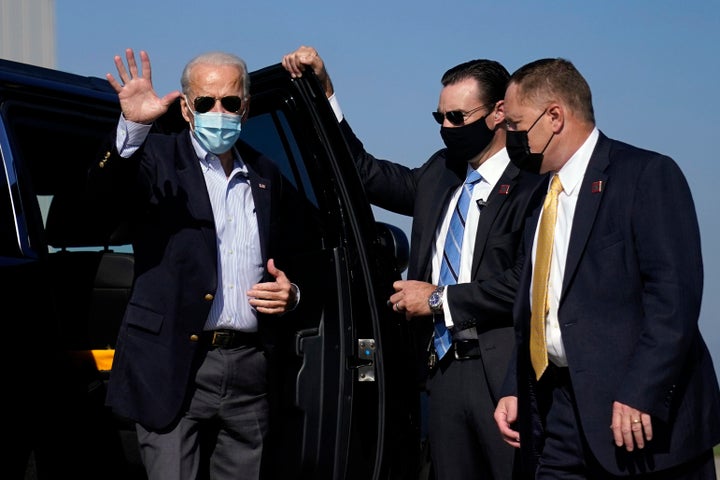 Joe Biden waves as he arrives to board his campaign plane at New Castle Airport in New Castle, Delaware, Thursday, Oct. 22, 2020, en route to Nashville.