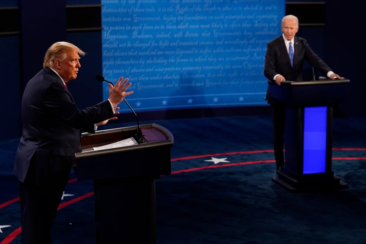 President Donald Trump answers a question as Democratic presidential candidate former Vice President Joe Biden listens during