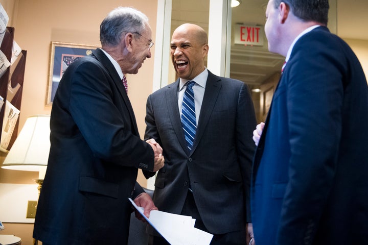 Sen. Cory Booker (D-N.J.) congratulates Republican Sens. Chuck Grassley (Iowa), left, and Mike Lee (Utah) on passage of the First Step Act.