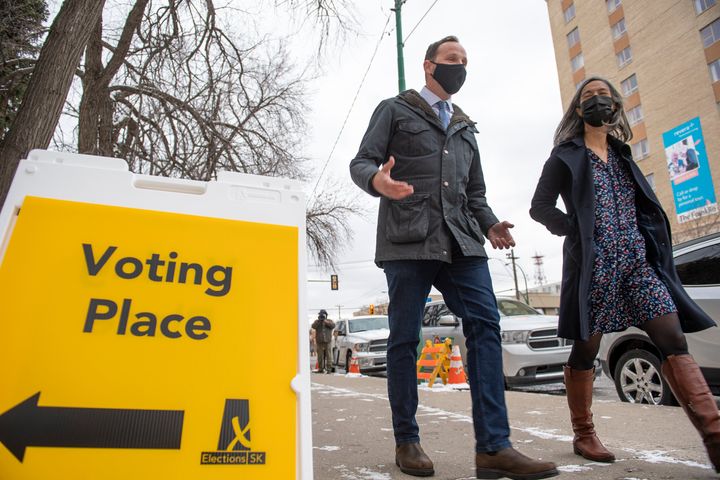 Saskatchewan New Democratic Party leader Ryan Meili, left, departing a polling station after voting in the advanced poll in Saskatoon, Tuesday, Oct. 20, 2020.