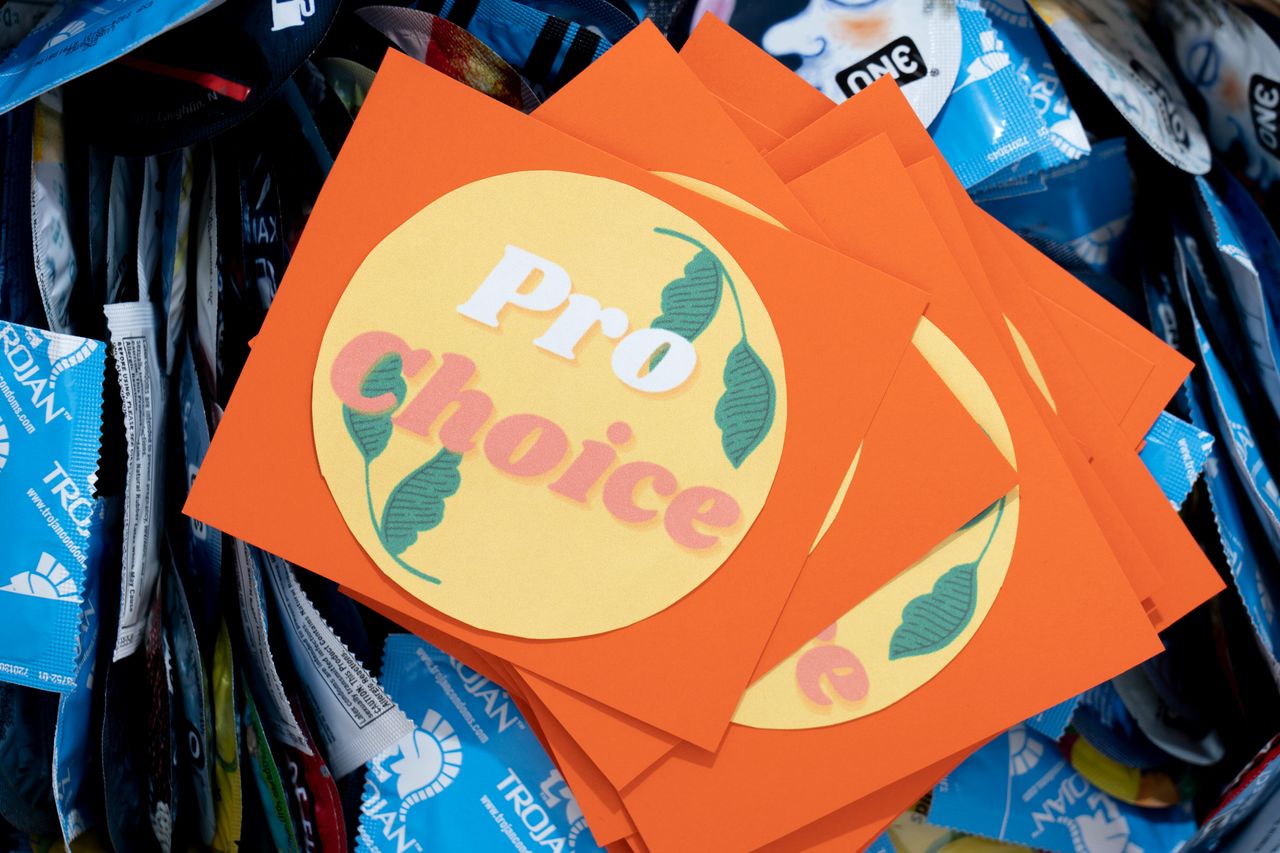 A pro-choice bumper sticker sits on a basket of condoms on campus at Saint Mary's College.