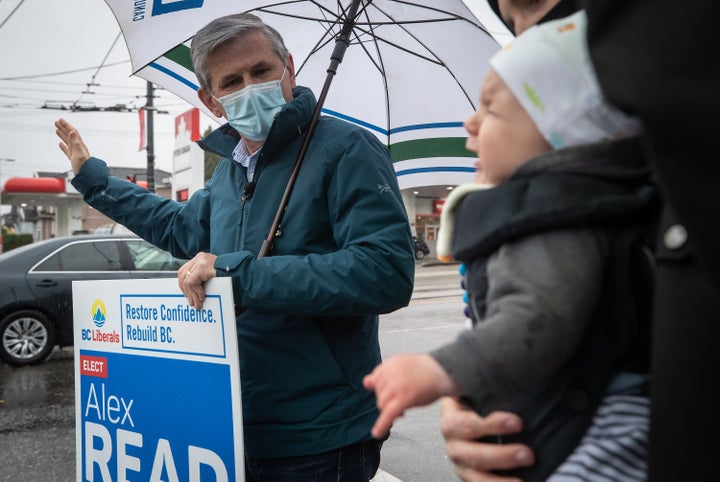 Liberal Leader Andrew Wilkinson waves to passing cars during a campaign stop in Vancouver on Oct. 23, 2020.