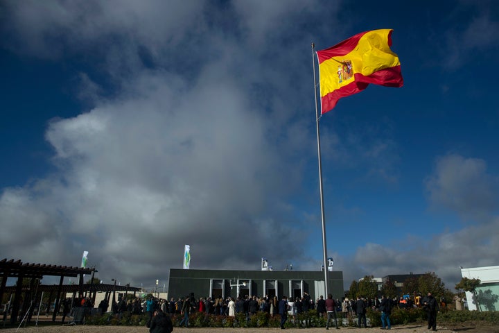 The Spanish flag flies during a memorial for coronavirus victims in Madrid, Spain, on Friday. Spanish Prime Minister Pedro Sa