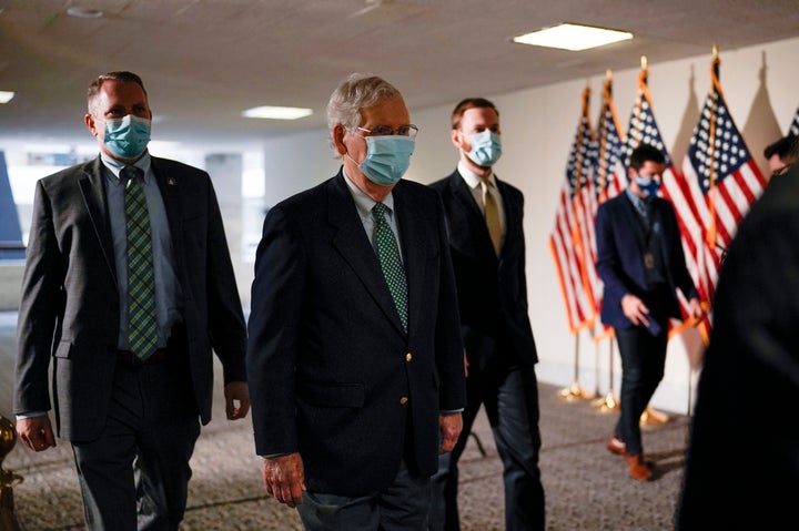 Senate Majority Leader Mitch McConnell, R-Ky., arrives as Republicans work during a rare weekend session to advance the confi