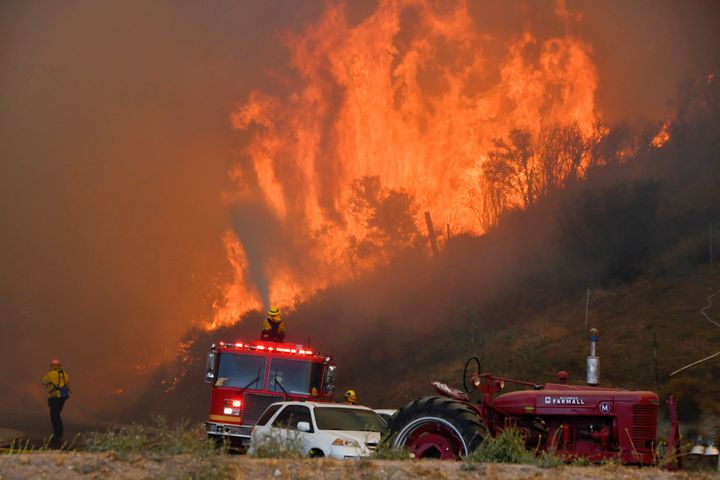 Firefighters arrive to battle the Tick fire, a wind-driven wildfire in the hills of Canyon Country north of Los Angeles on Oct. 24.